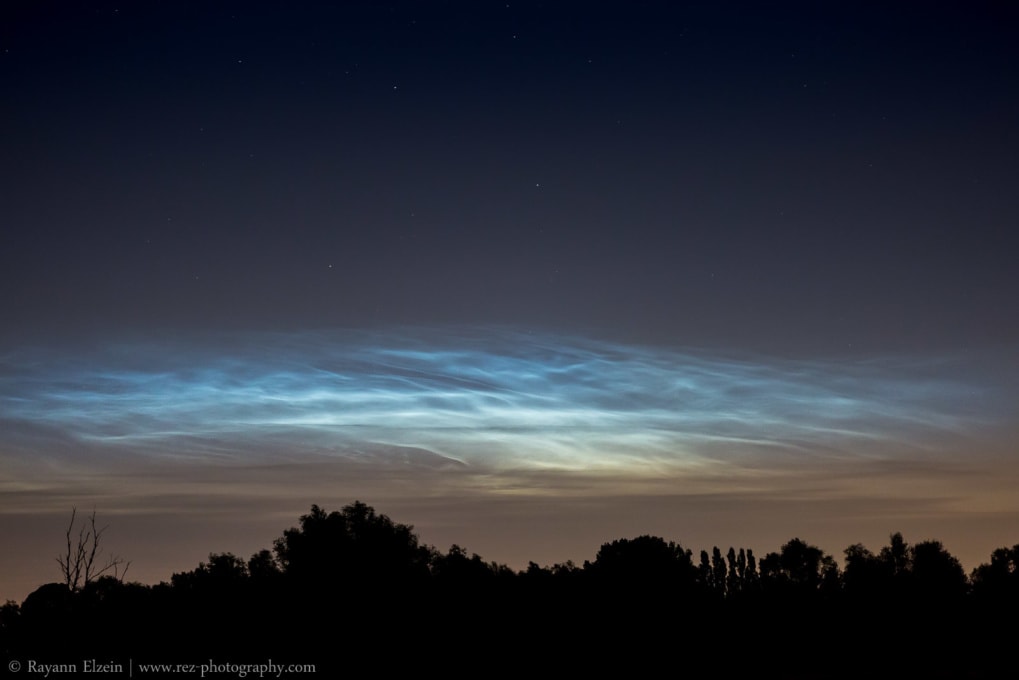 How to photograph noctilucent clouds: a brilliant display above silhouette trees