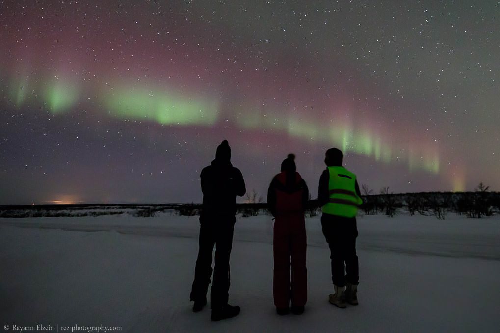 My Aurora photography tour guests under the Northern Lights