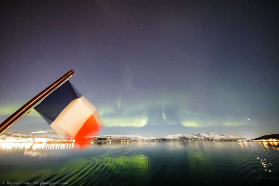 Northern lights reflected above water during our Norway winter cruise