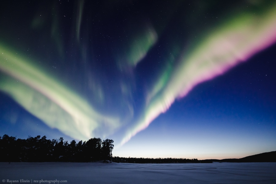 Green and purple aurora just after sunset near Inari in Finnish Lapland